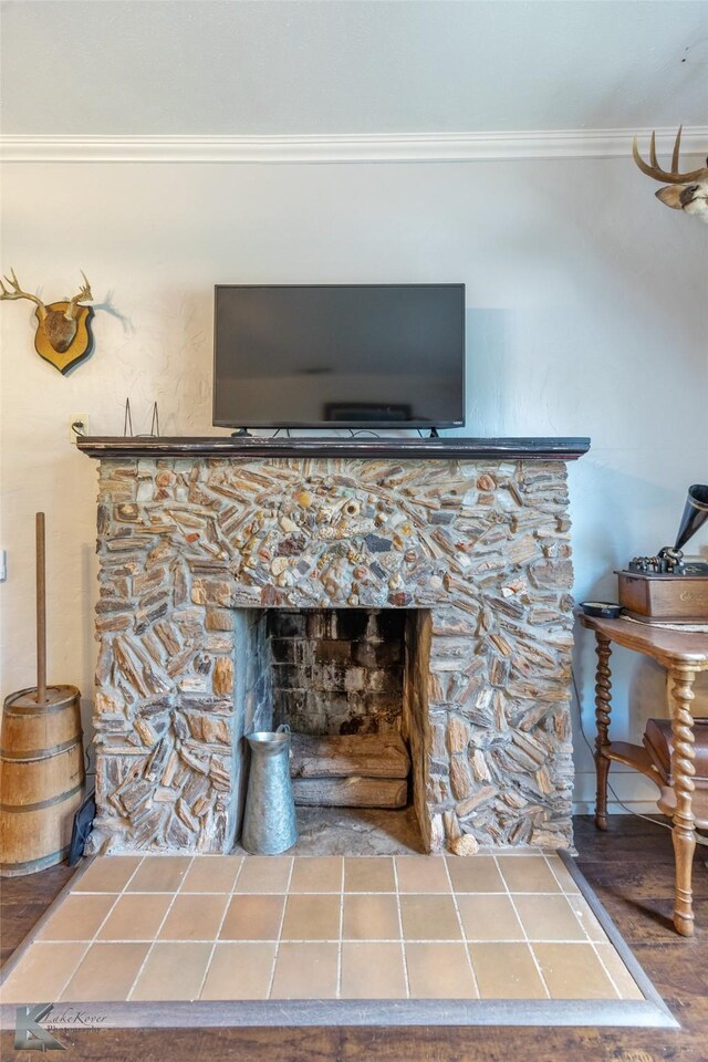 202 E Ross St, Rising Star, TX 76471 - detailed view of ornamental molding, a stone fireplace, and wood finished floors