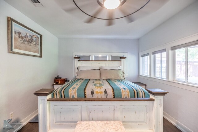202 E Ross St, Rising Star, TX 76471 - bedroom with baseboards, wood finished floors, and ceiling fan