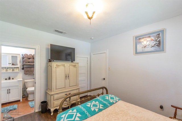 202 E Ross St, Rising Star, TX 76471 - bedroom with wood finished floors and ensuite bath