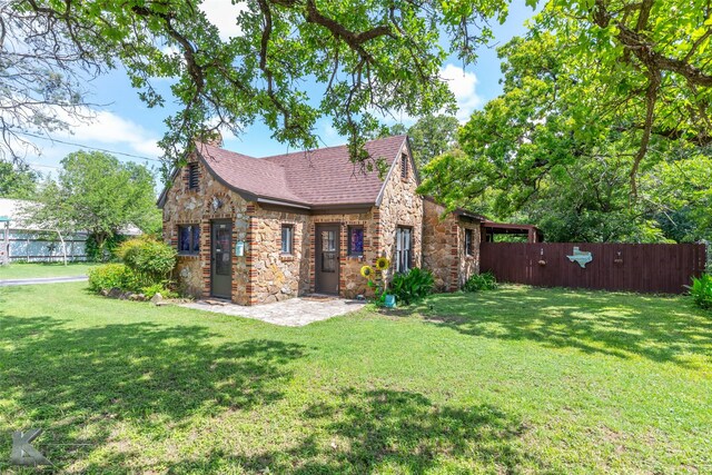 202 E Ross St, Rising Star, TX 76471 - view of front of property featuring stone siding and roof with shingles