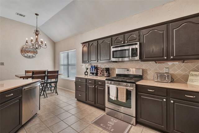 2700 Rochelle Dr, Mckinney, TX 75070 - kitchen featuring appliances with stainless steel finishes, a chandelier, light countertops, and vaulted ceiling