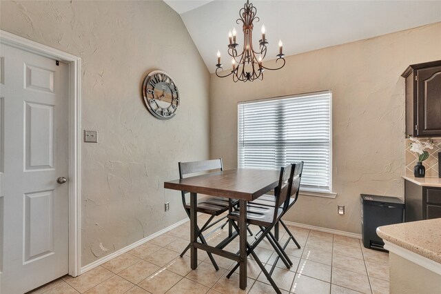 2700 Rochelle Dr, Mckinney, TX 75070 - dining area with lofted ceiling, a chandelier, light tile patterned flooring, a textured wall, and baseboards
