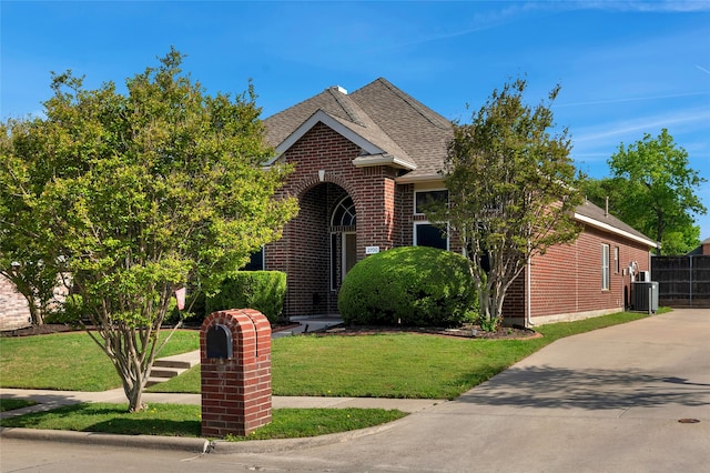 2700 Rochelle Dr, Mckinney, TX 75070 - view of front of property featuring central AC, brick siding, and a shingled roof