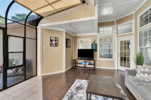 2700 Rochelle Dr, Mckinney, TX 75070 - living area with wood finished floors, baseboards, wooden walls, and plenty of natural light