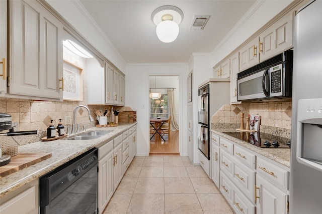 5909 Shady Hill Ln, Arlington, TX 76016 - kitchen featuring black appliances, a sink, tasteful backsplash, crown molding, and light stone countertops