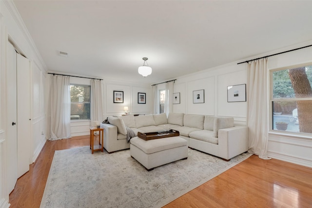 5909 Shady Hill Ln, Arlington, TX 76016 - living area with light wood finished floors, healthy amount of natural light, a decorative wall, and ornamental molding