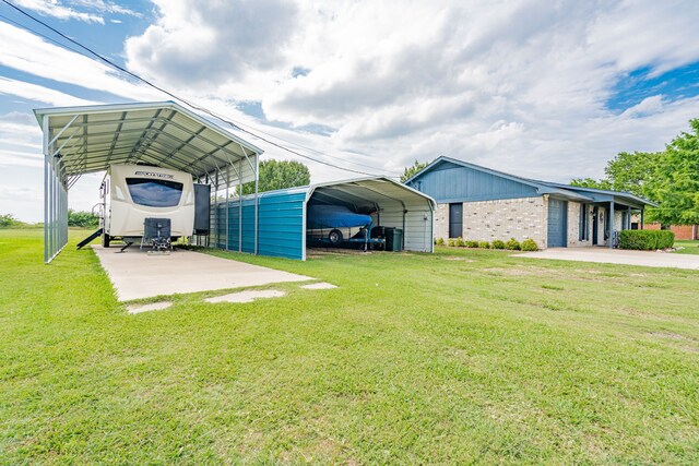 1100 Cartwright Ln, Kaufman, TX 75142 - exterior space featuring a detached carport, a yard, brick siding, and driveway