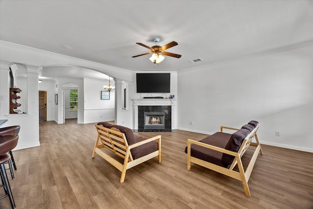 204 Leonard Way, Fate, TX 75087 - living area with ceiling fan, arched walkways, a high end fireplace, ornate columns, and wood finished floors