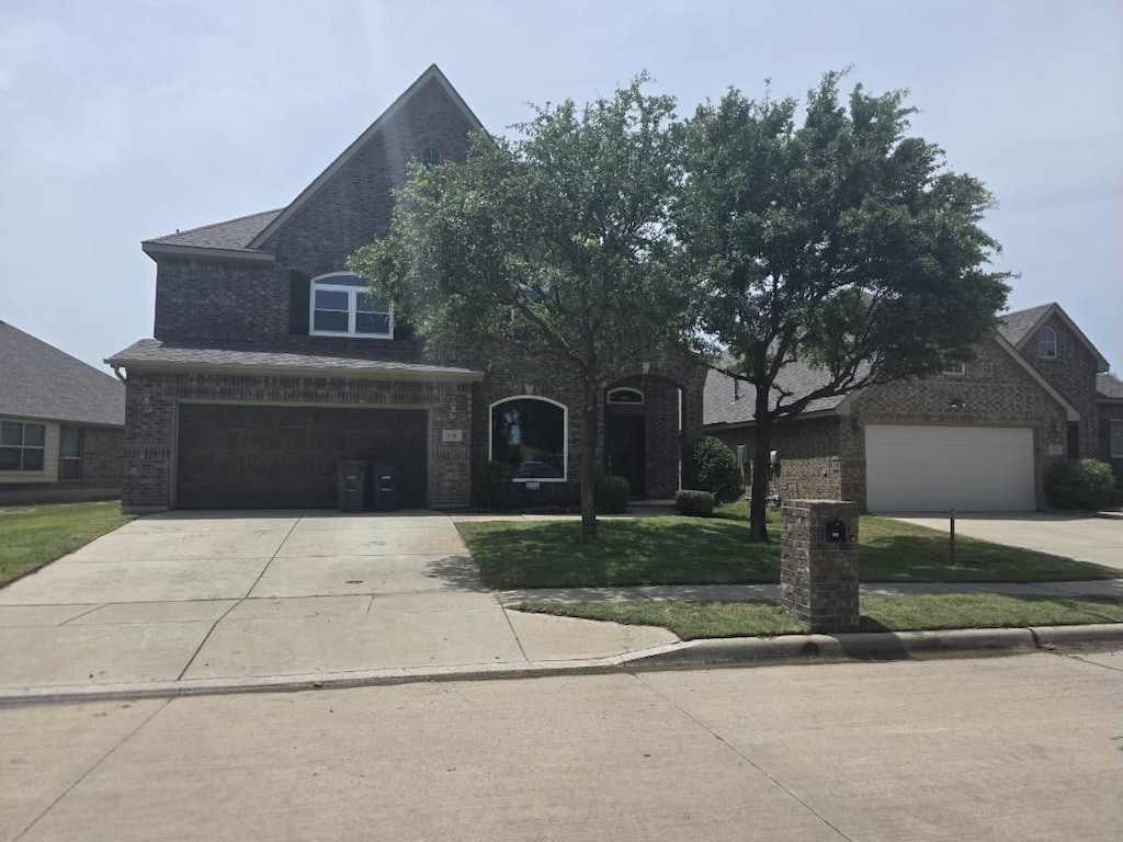1116 Albany Dr, Fort Worth, TX 76131 - view of front of home featuring concrete driveway, brick siding, a front lawn, and a garage