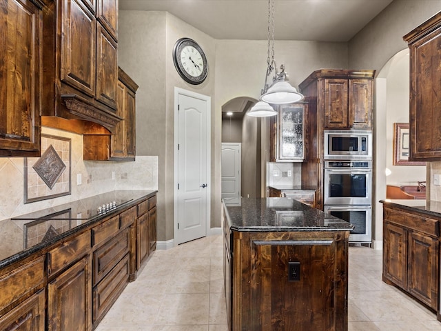 901 Egan Way Ct, Burleson, TX 76028 - kitchen featuring arched walkways, appliances with stainless steel finishes, and dark stone countertops