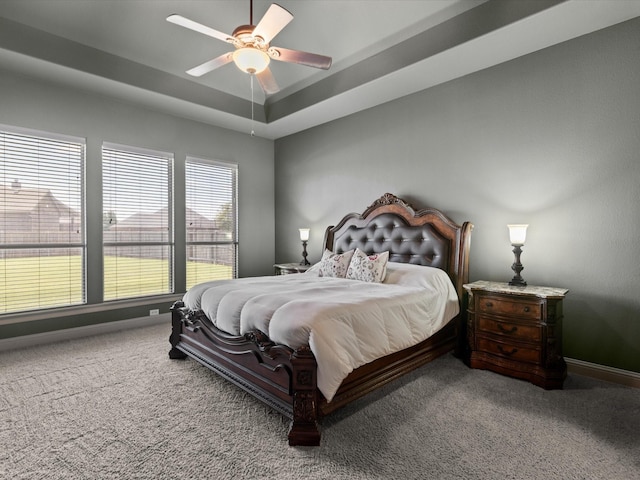 901 Egan Way Ct, Burleson, TX 76028 - carpeted bedroom featuring a raised ceiling, baseboards, and a ceiling fan