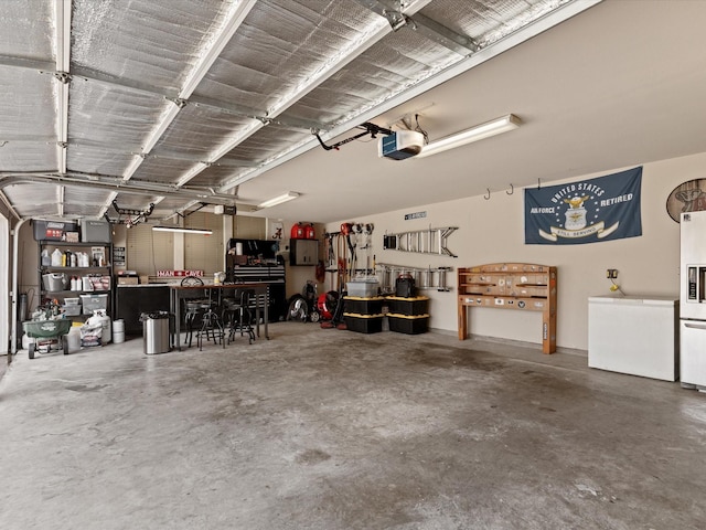 901 Egan Way Ct, Burleson, TX 76028 - garage featuring a garage door opener, fridge, and a workshop area