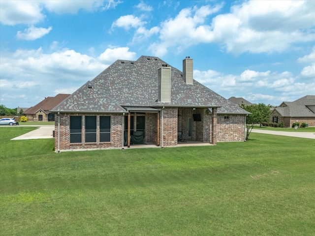 901 Egan Way Ct, Burleson, TX 76028 - rear view of house with a chimney, a lawn, and brick siding