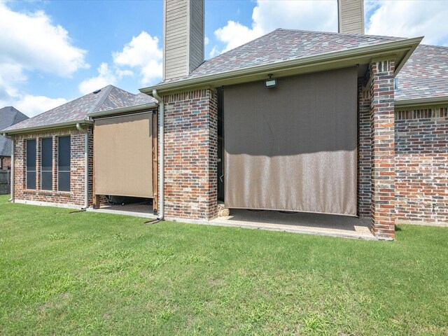 901 Egan Way Ct, Burleson, TX 76028 - view of home's exterior with a chimney, a yard, and brick siding