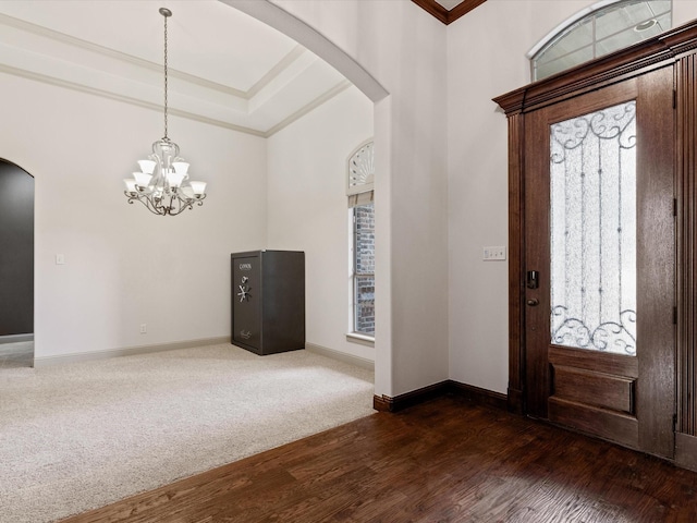 901 Egan Way Ct, Burleson, TX 76028 - entrance foyer featuring arched walkways, crown molding, dark wood-style flooring, a chandelier, and baseboards