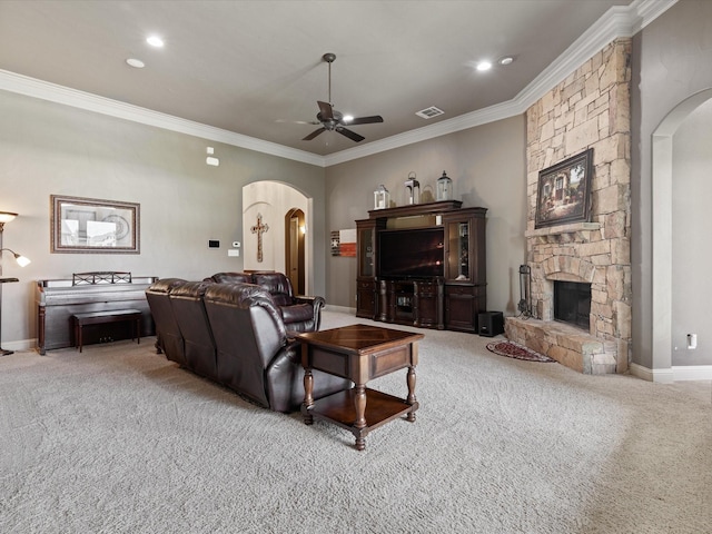 901 Egan Way Ct, Burleson, TX 76028 - carpeted living area with arched walkways, a ceiling fan, ornamental molding, a stone fireplace, and baseboards