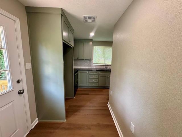 924 Gurley Ln, Waco, TX 76706 - hall featuring dark wood-style floors, baseboards, and a sink