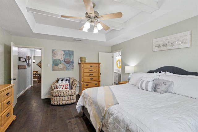 1133 Harris Ave, Hurst, TX 76053 - bedroom with a tray ceiling, dark wood-style flooring, baseboards, a ceiling fan, and ensuite bath