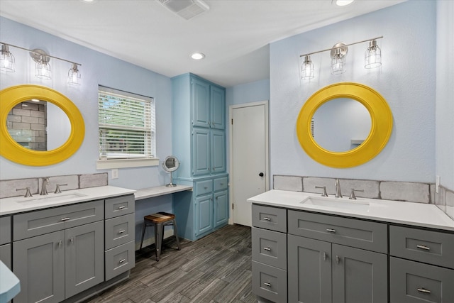 1133 Harris Ave, Hurst, TX 76053 - full bath with two vanities, wood finished floors, and recessed lighting