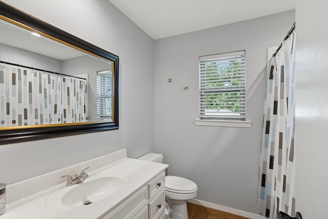1133 Harris Ave, Hurst, TX 76053 - bathroom with vanity, toilet, baseboards, tile patterned flooring, and a shower with shower curtain