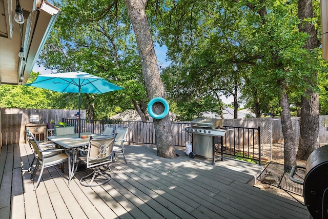 1133 Harris Ave, Hurst, TX 76053 - wooden terrace with outdoor dining space, a fenced backyard, and area for grilling