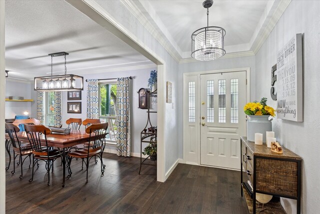 1133 Harris Ave, Hurst, TX 76053 - foyer featuring dark wood finished floors, a chandelier, baseboards, and crown molding