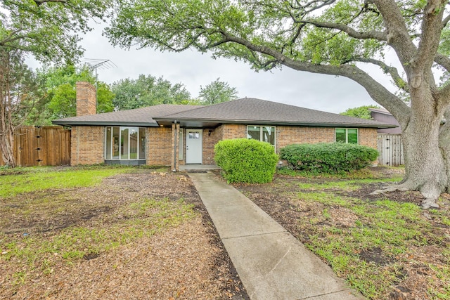 1601 Elk Grove Dr, Richardson, TX 75081 - single story home with a chimney, brick siding, a gate, and roof with shingles