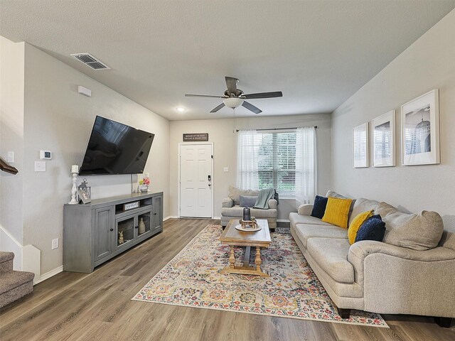 801 Billups Dr, Van Alstyne, TX 75495 - living room with ceiling fan, wood finished floors, stairs, and baseboards