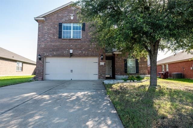 3412 Spruce St, Royse City, TX 75189 - view of front of property with brick siding, a garage, driveway, central AC, and a front yard