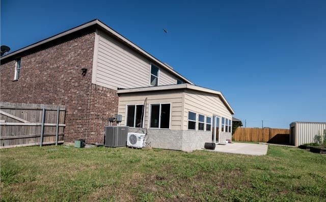 3412 Spruce St, Royse City, TX 75189 - rear view of house featuring a patio, central AC, brick siding, and ac unit