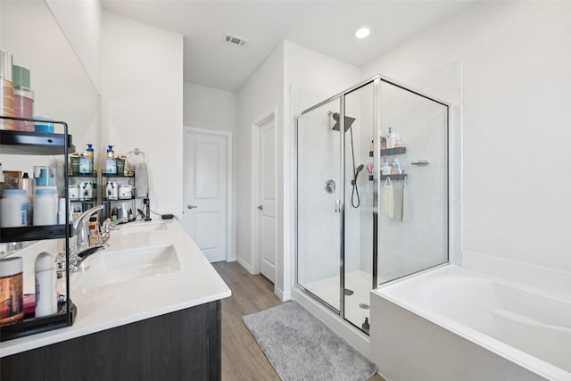 2028 Saddle Way, Mesquite, TX 75149 - bathroom with a shower stall, wood finished floors, a garden tub, and double vanity