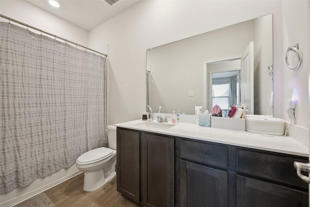 2028 Saddle Way, Mesquite, TX 75149 - bathroom with double vanity, wood finished floors, toilet, and shower / bath combo with shower curtain