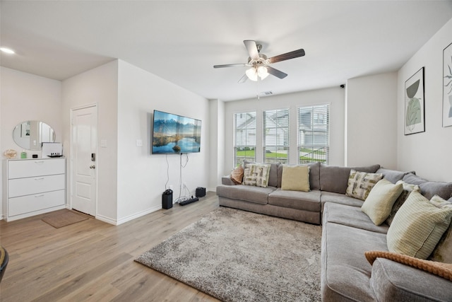 2028 Saddle Way, Mesquite, TX 75149 - living room with light wood finished floors, a ceiling fan, and baseboards