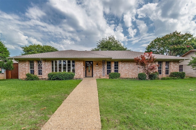 4023 Candlenut Ln, Dallas, TX 75244 - ranch-style home with a front lawn and brick siding