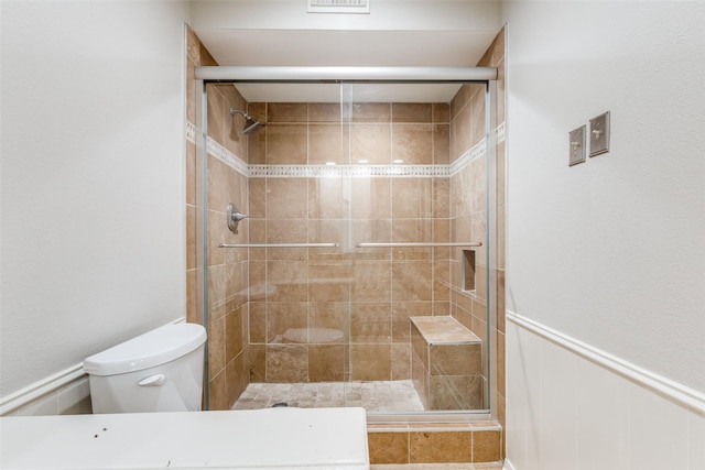 4023 Candlenut Ln, Dallas, TX 75244 - bathroom with toilet, a stall shower, and a wainscoted wall