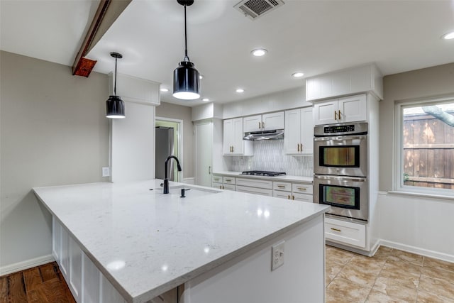 4023 Candlenut Ln, Dallas, TX 75244 - kitchen with stainless steel appliances, a sink, baseboards, decorative backsplash, and recessed lighting