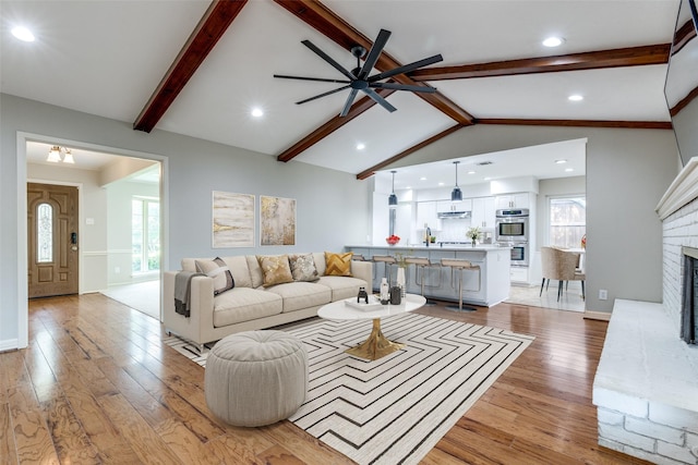 4023 Candlenut Ln, Dallas, TX 75244 - living room with light wood finished floors, a ceiling fan, a brick fireplace, healthy amount of natural light, and recessed lighting