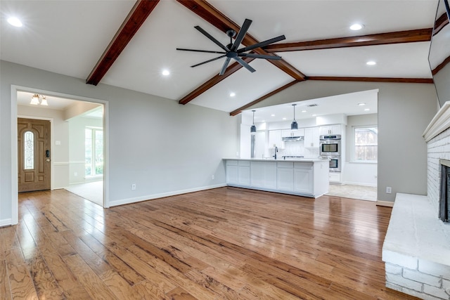 4023 Candlenut Ln, Dallas, TX 75244 - unfurnished living room featuring light wood-style flooring, ceiling fan, a brick fireplace, baseboards, and recessed lighting