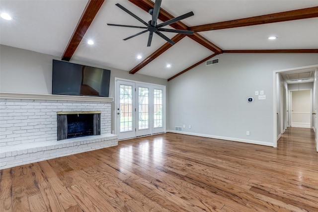 4023 Candlenut Ln, Dallas, TX 75244 - unfurnished living room with attic access, wood finished floors, ceiling fan, a brick fireplace, and baseboards