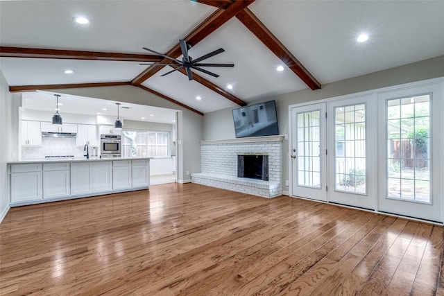 4023 Candlenut Ln, Dallas, TX 75244 - unfurnished living room featuring light wood-type flooring, ceiling fan, plenty of natural light, a sink, and recessed lighting
