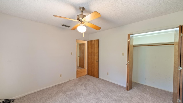 1015 Monte Carlo Dr, Grand Saline, TX 75140 - unfurnished bedroom featuring carpet floors, a ceiling fan, a closet, and a textured ceiling