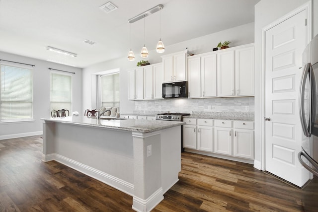 15717 Preble Rd, Fort Worth, TX 76177 - kitchen with black microwave, a sink, decorative backsplash, and white cabinetry