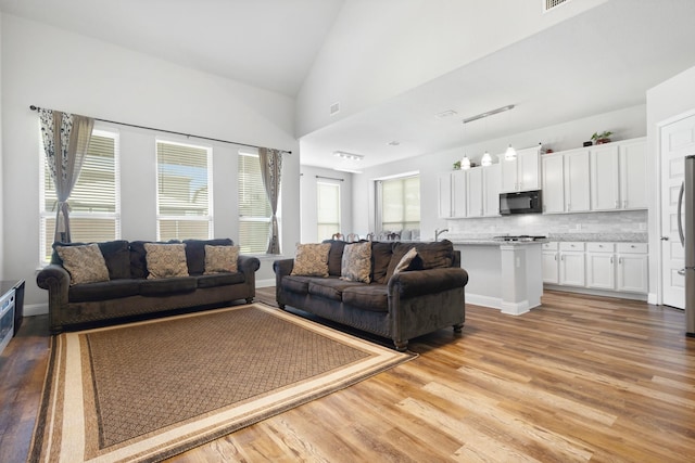 15717 Preble Rd, Fort Worth, TX 76177 - living room with light wood-style flooring and high vaulted ceiling