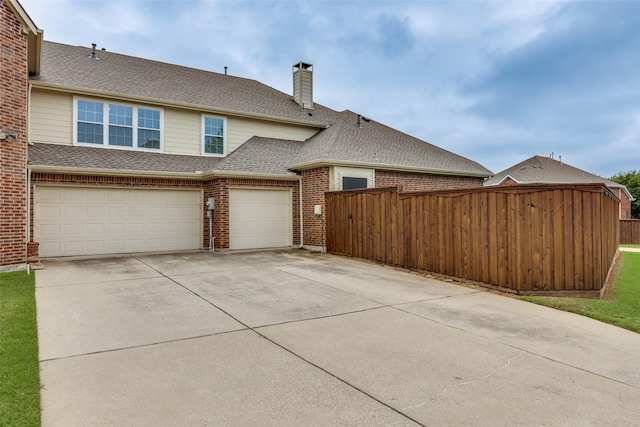 1616 Teakwood Dr, Wylie, TX 75098 - view of side of property featuring concrete driveway, a shingled roof, brick siding, a chimney, and a garage