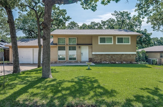 141 Stonegate Ct, Bedford, TX 76022 - view of front of house with stone siding, an attached garage, a front lawn, and concrete driveway