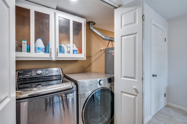 141 Stonegate Ct, Bedford, TX 76022 - laundry area featuring washing machine and dryer, water heater, and light tile patterned floors