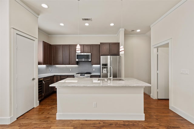 5909 Ross Ave Unit 2, Dallas, TX 75206 - kitchen with stainless steel appliances, a sink, dark brown cabinets, backsplash, and crown molding