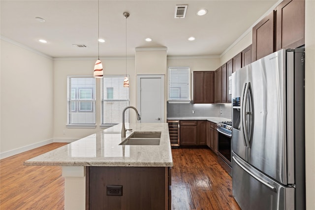 5909 Ross Ave Unit 2, Dallas, TX 75206 - kitchen with appliances with stainless steel finishes, a sink, crown molding, a center island with sink, and tasteful backsplash