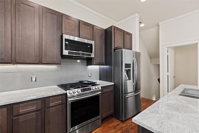 5909 Ross Ave Unit 2, Dallas, TX 75206 - kitchen featuring stainless steel appliances, dark brown cabinets, dark wood finished floors, decorative backsplash, and light stone counters