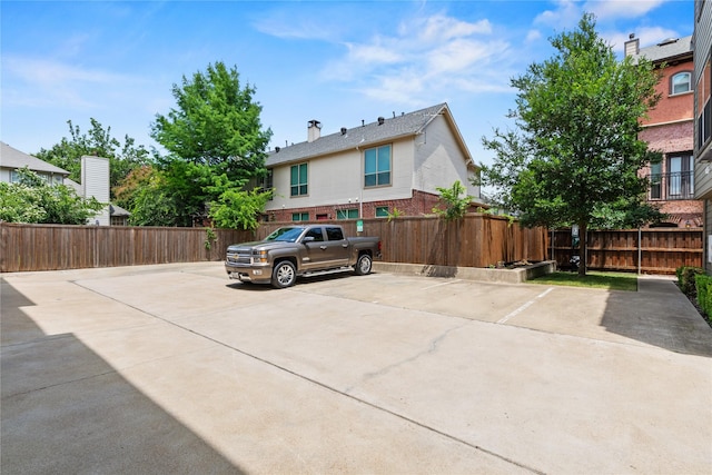 5909 Ross Ave Unit 2, Dallas, TX 75206 - view of front of home with brick siding, uncovered parking, and a chimney